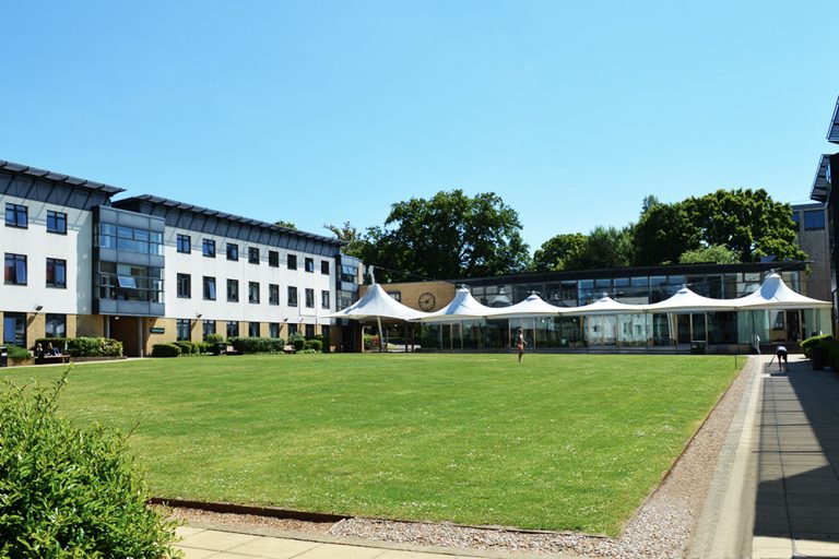 White building with green square lawn