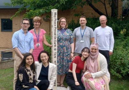Southlands College staff gather with Maki and her daughter Miki next to the College's peace pole.